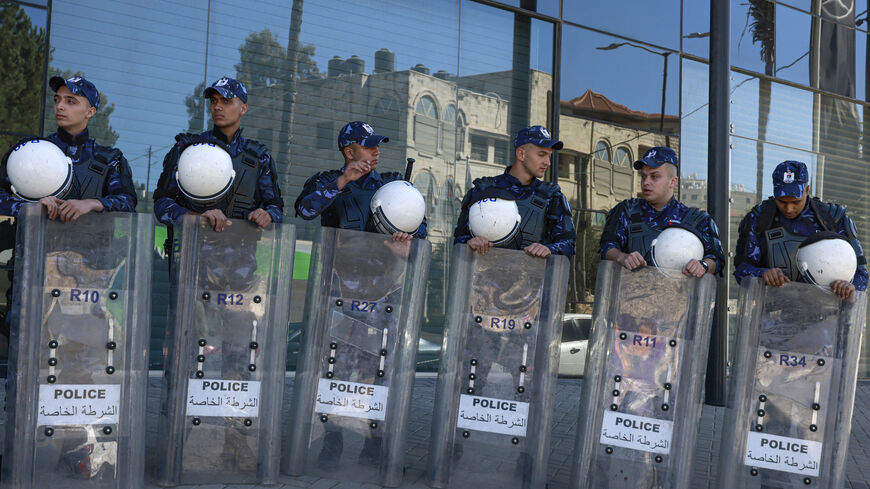 Palestinian security forces close off the entrance of a building housing the offices of Saudi broadcasters MBC, Al-Arabiya, and Al-Hadath in Ramallah in the occupied West Bank on October 21, 2024, during a protest calling for their closure against the backdrop of their descriptions of Hamas leadership which the protesters reject. (Photo by Jaafar ASHTIYEH / AFP) (Photo by JAAFAR ASHTIYEH/AFP via Getty Images)