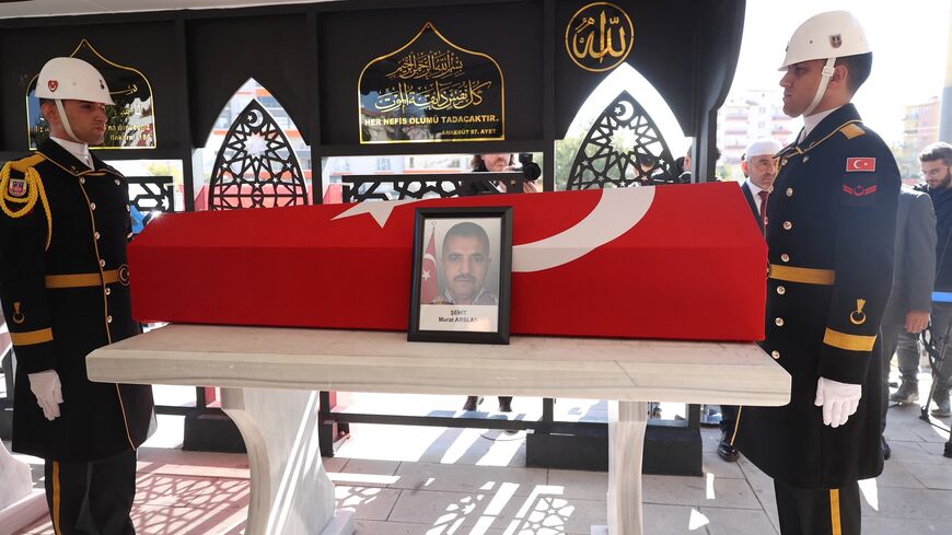 Military honour guards stand next to the coffin of taxi driver Murat Arslan, the day after he was killed in an attack at a state-run aerospace industries building in Ankara, October 24, 2024.