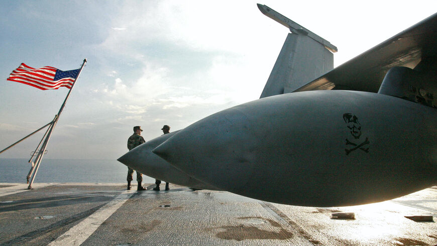 US navy men stand aboard the USS Eisenhower, one of the world's largest warships, off the Cypriot coast, Oct. 25, 2006.