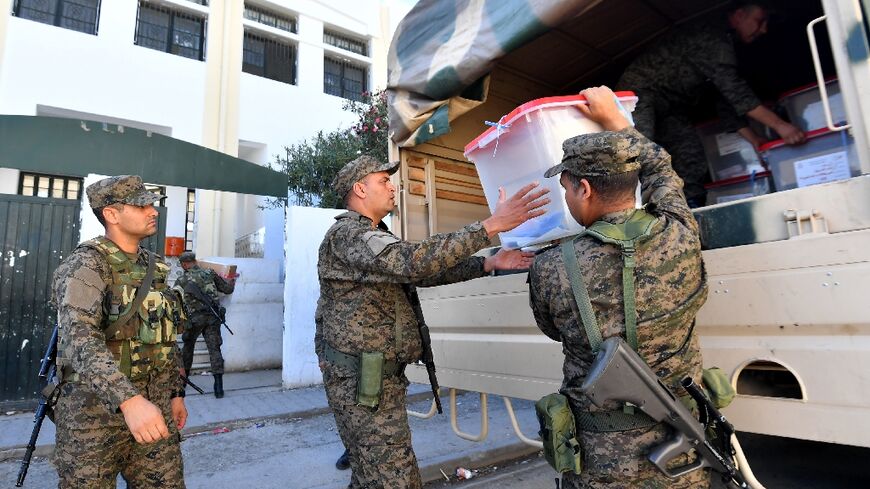 Tunisian soldiers deliver ballot boxes to a polling station in Ariana near Tunis a day before the vote