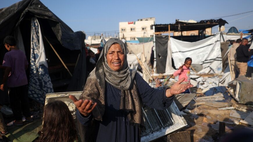 Displaced Palestinians in the aftermath of an Israeli strike that hit tents in the central Gaza Strip