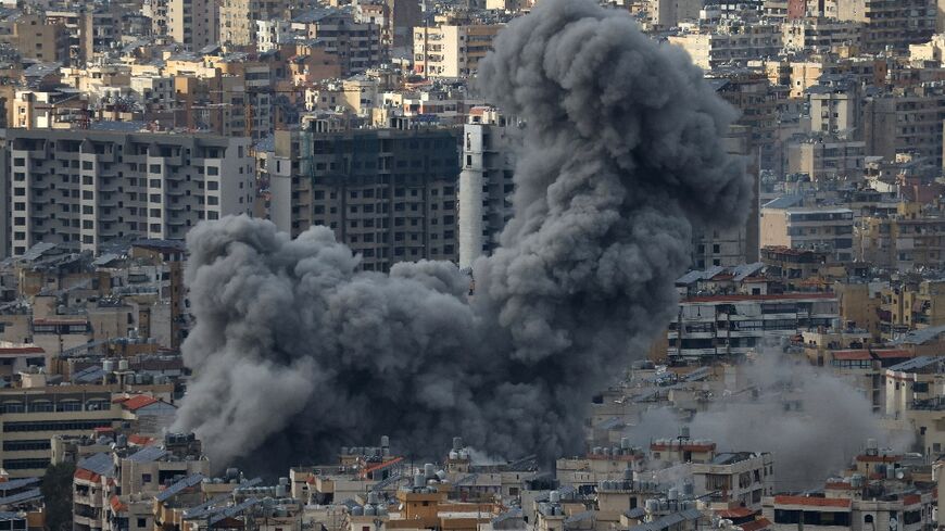 Smoke billows from the site of Israeli air strikes on Beirut's southern suburbs on November 25