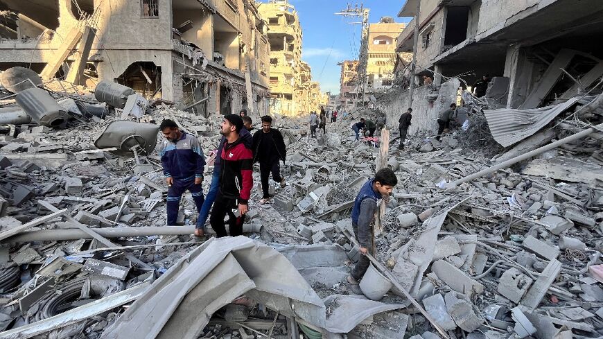 People check the rubble of a building hit in a deadly Israeli strike on Beit Lahia, northern Gaza