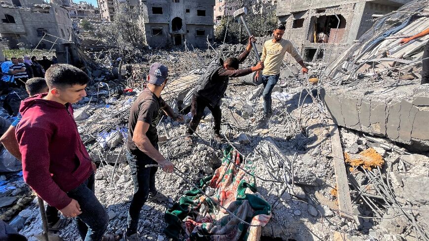 People search the rubble for people missing after an Israeli strike in Beit Lahia