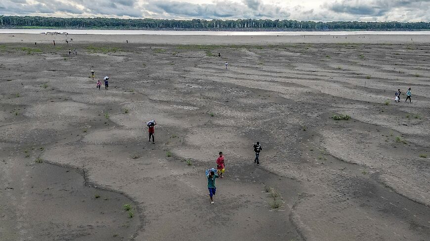 Inigenous Yagua people are forced to travel long distances to fetch water after drought in the upper Amazon valley cut the river's flow by 90 percent, according to Colombian authorities.