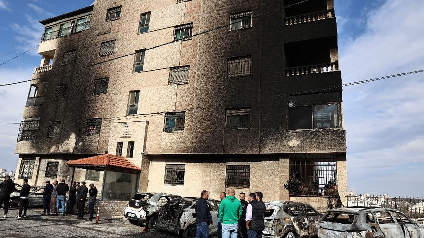 Burned vehicles and scorched walls after a reported attack by Israeli settlers on the outskirts of Ramallah in the occupied West Bank on November 4, 2024