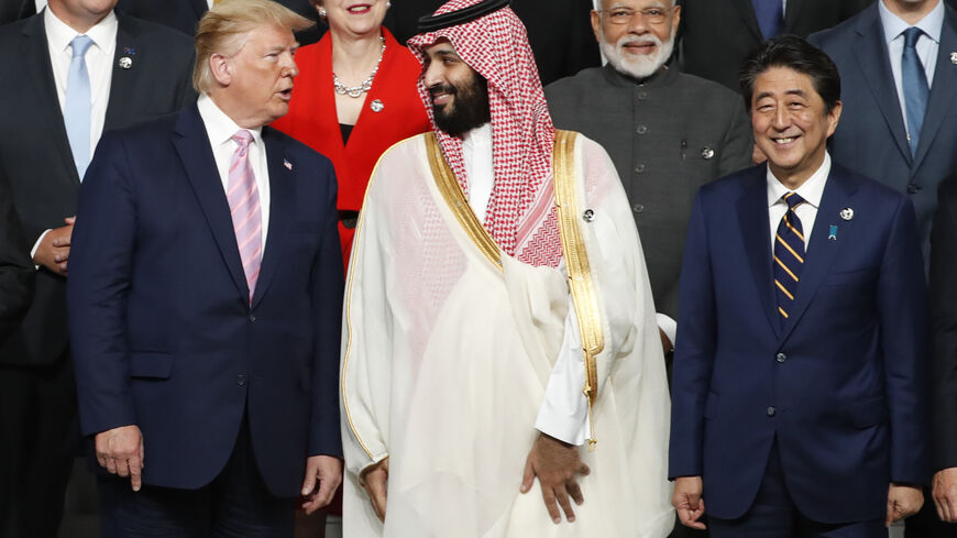 US President Donald Trump (L) speaks with Saudi Arabia's Crown Prince Mohammed bin Salman (C) as Japanese Prime Minister Shinzo Abe (R), Indian Prime Minister Narendra Modi (2nd R) and Britain's Prime Minister Theresa May smile during a family photo session at the G20 Summit in Osaka on June 28, 2019. (Photo by KIM KYUNG-HOON / POOL / AFP) (Photo credit should read KIM KYUNG-HOON/AFP via Getty Images)