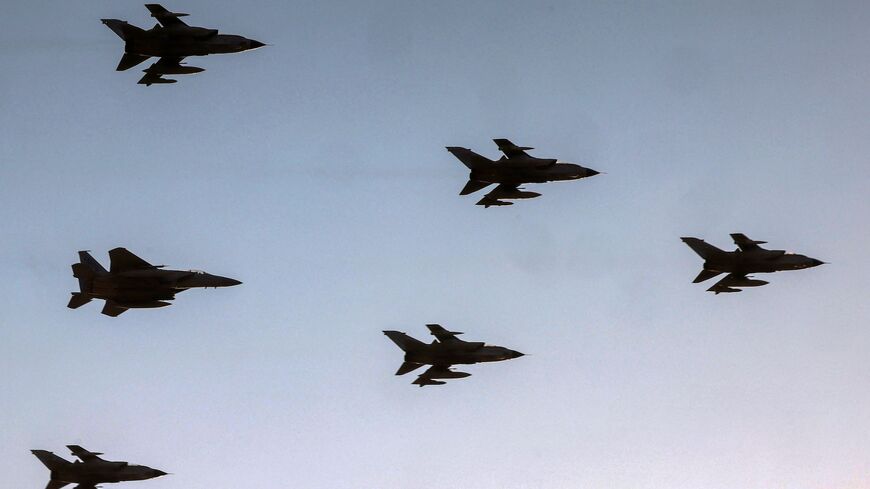 Royal Saudi Air Force Panavia Tornado and F-15 Eagle fighter aircraft fly over during an airshow.