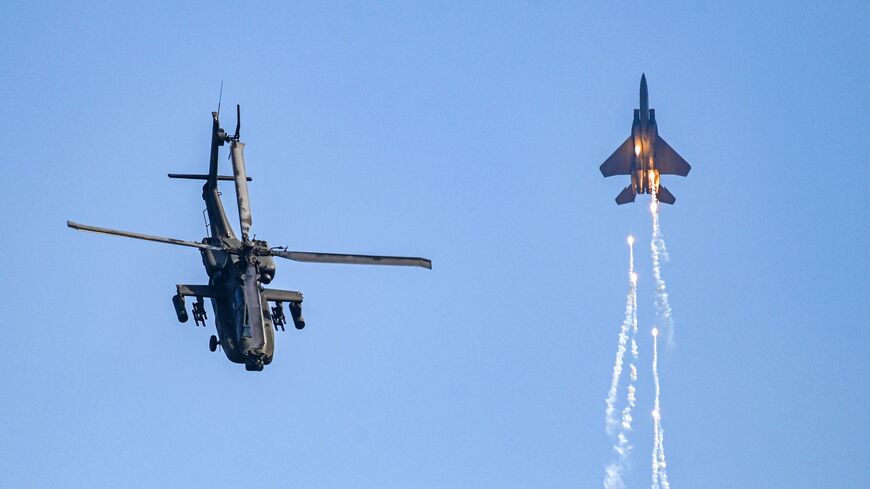 Singaporean Air Force's F-15SG fighter jet and Apache helicopter perform during a preview of the Singapore Airshow in Singapore on Feb. 18, 2024. 