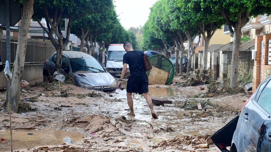 A man walks in a street covered in mud in a flooded area in Picanya, near Valencia, eastern Spain, on Oct. 30, 2024.