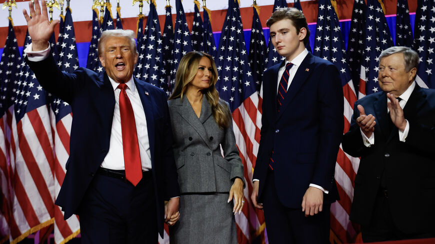 WEST PALM BEACH, FLORIDA - NOVEMBER 06: Republican presidential nominee, former U.S. President Donald Trump waves to supporters with former first lady Melania Trump and Barron Trump during an election night event at the Palm Beach Convention Center on November 06, 2024 in West Palm Beach, Florida. Americans cast their ballots today in the presidential race between Republican nominee former President Donald Trump and Vice President Kamala Harris, as well as multiple state elections that will determine the ba