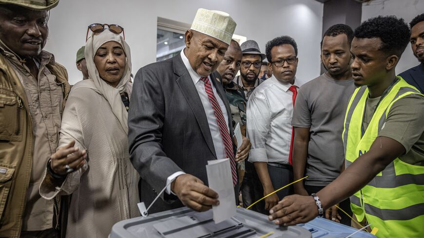 Waddani Party presidential candidate Abdirahman Mohamed Abdullahi, also known as Irro, (C) casts his vote at a polling station.