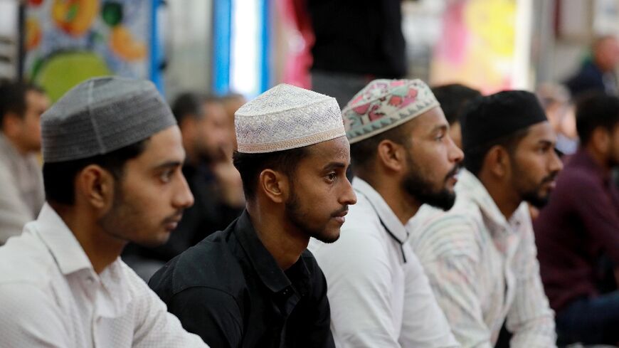 Foreign workers in Iraq attend prayers at Baghdad's Abdul Qader al-Jilani mosque. The country, better
known for its own exodus of refugees, is home to hundreds of thousands.