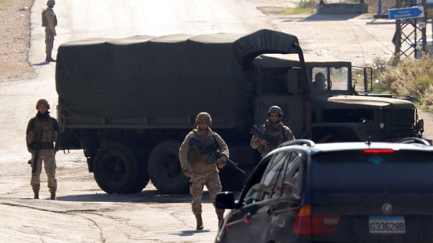 Lebanese army soldiers manning a checkpoint, use a military vehicle to block a road in southern Lebanon's Marjayoun area