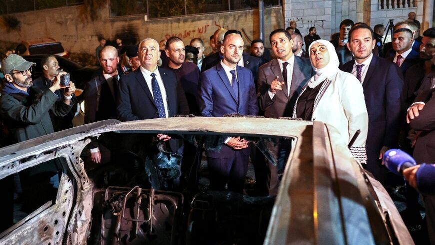 French Foreign Minister Jean-Noel Barrot (C) inspects cars torched in an attack by Israeli settlers on the West Bank town of Al-Bireh, adjacent to Ramallah