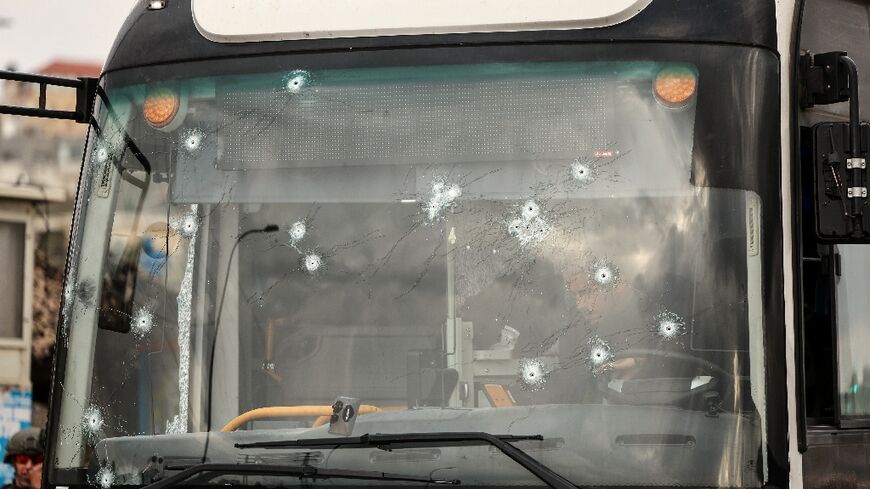 The shooting left more than a dozen bullet holes in the bus windshield 