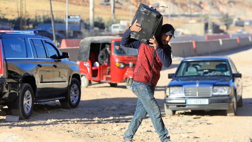 Taxis and tuktuks are seen at the Masnaa crossing between Lebanon and Syria