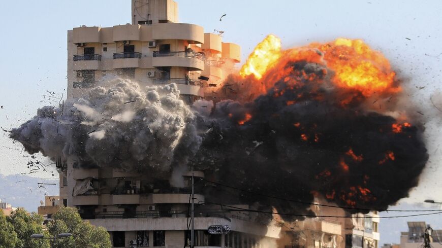 An Israeli missile hits an 11-storey building in south Beirut, triggering a fireball in the normally busy  Shiyah district