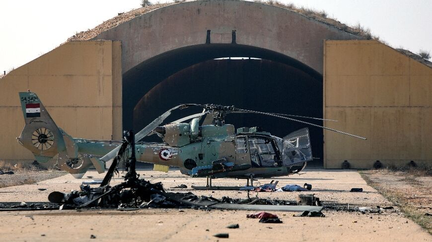 A burned-out helicopter at the Mazzeh air base outside Damascus following Israeli air strikes