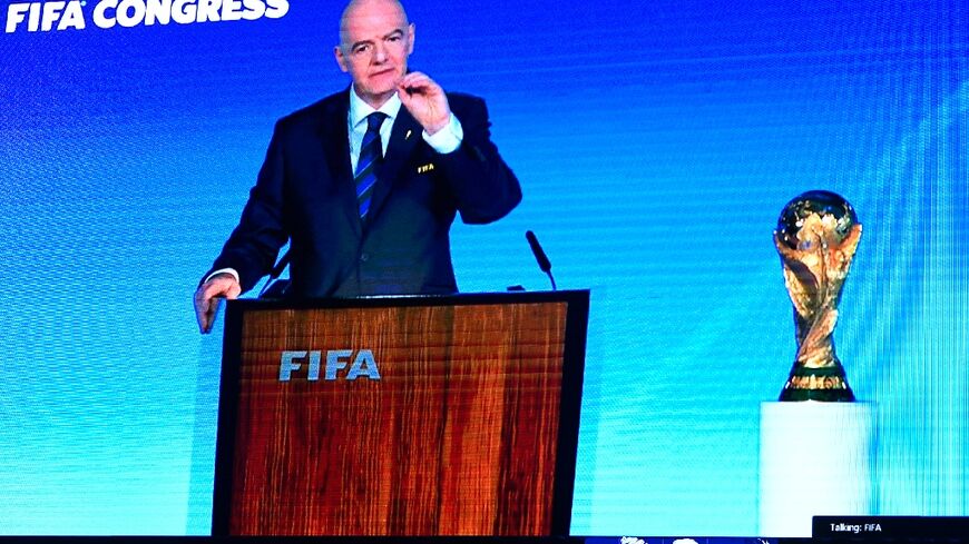 A speech by FIFA president Gianni Infantino is broadcast on a screen in Saudi's capital Riyadh as the Gulf kingdom is confirmed as 2034 World Cup host