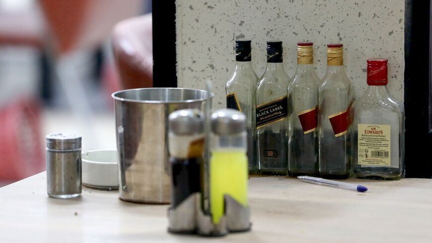 Empty whisky bottles on the bar of a Baghdad club ordered closed by Iraqi security forces 