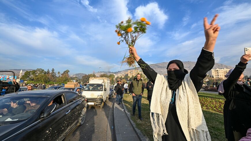 People at Umayyad Square in Damascus celebrate the end of Syrian president Bashar al-Assad's rule