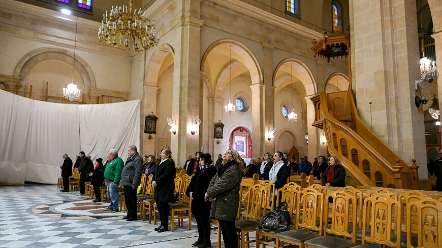 Syrian Christians attend mass at the Latin cathedral in Aleppo, uncertain what the future will hold.