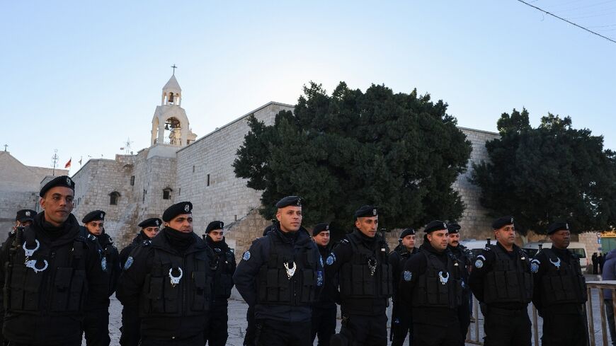 Palestinian policemen stand guard at Manger Square on Christmas eve outside Bethlehem's Church of the Nativity