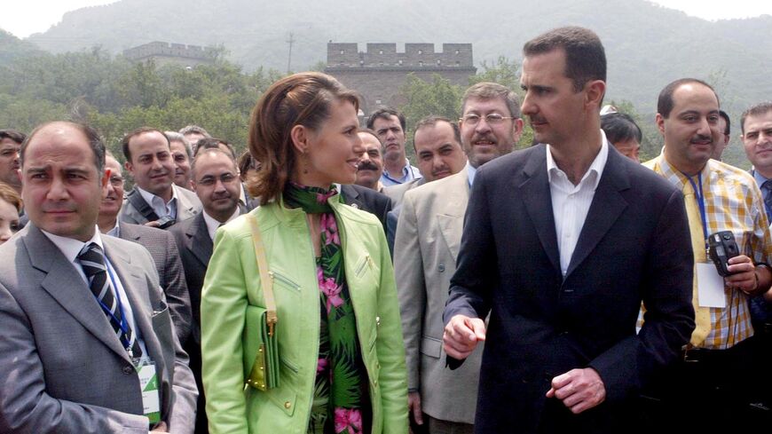  Visiting Syrian President Bashar al-Assad (R) and his wife, Asma, (C) visit the Great Wall near Beijing, on June 22, 2004, during the Middle East leader's first full day in the Chinese capital.