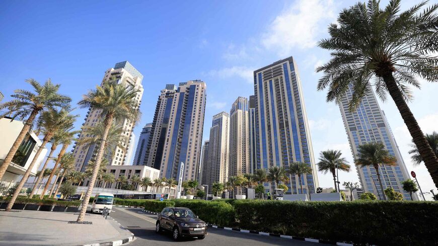  Cars drive along a street in front of high-rise buildings in Dubai, on Feb. 18, 2023. 