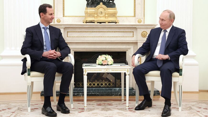 In this pool photograph distributed by the Russian state agency Sputnik on July 25, 2024, Russia's President Vladimir Putin (R) meets with Syria's President Bashar al-Assad at the Kremlin in Moscow on July 24, 2024. 