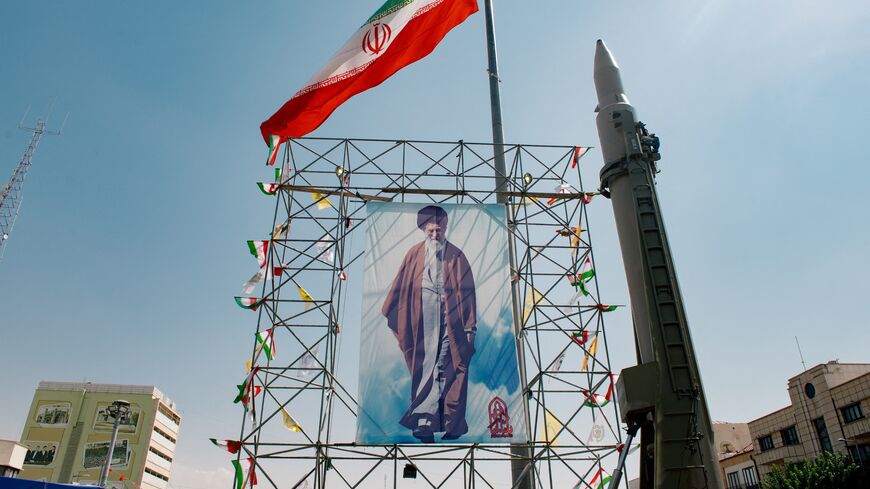 A banner depicting Iran's supreme leader, Ayatollah Ali Khamenei, stands next to a ballistic missile in Baharestan Square, Tehran, Sept. 26, 2024.