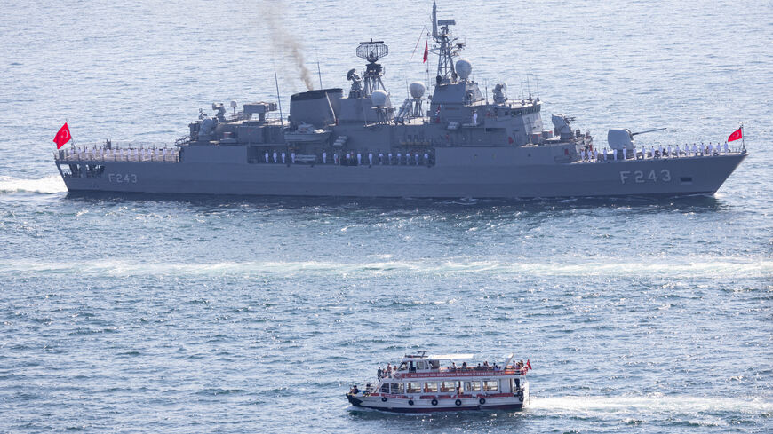 ISTANBUL, TURKEY - SEPTEMBER 27: A ferry passes a Turkish Navy vessel navigating the Bosphorus in a parade to mark the 486th anniversary of the Naval victory of Preveza and naval forces day on September 27, 2024 in Istanbul, Turkey. 16 vessels from the Turkish Naval Forces Command took part in the parade. (Photo by Chris McGrath/Getty Images)