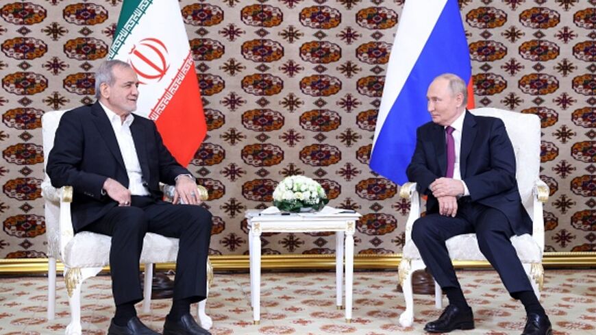 In this pool photograph distributed by the Russian state agency Sputnik, Russia's President Vladimir Putin meets with Iran's President Masoud Pezeshkian on the sidelines of an international forum "Interrelation of times and civilizations - basis of peace and development" dedicated to the 300th anniversary of poet Magtymguly Fragi's birthday in Ashgabat on October 11, 2024. (Photo by Alexander SHCHERBAK / POOL / AFP) (Photo by ALEXANDER SHCHERBAK/POOL/AFP via Getty Images)