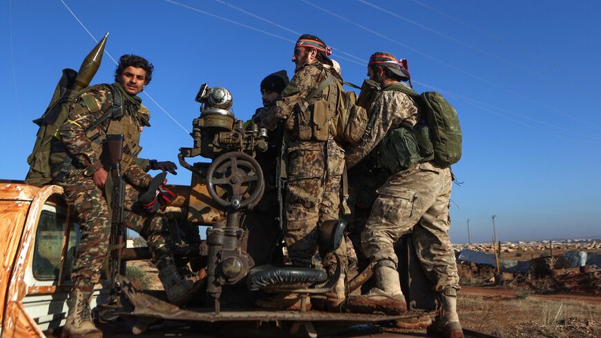 Fighters deploy in Atareb, in the western areas of Syria's northern Aleppo province, amid clashes between the Syrian army and fighters of the jihadist group Hayat Tahrir al-Sham along with allied factions, Nov. 28, 2024.