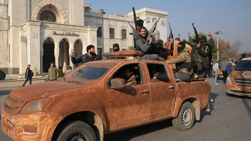 Syrian anti-government fighters celebrate as they pour into the captured city of Hama, Dec. 6, 2024.