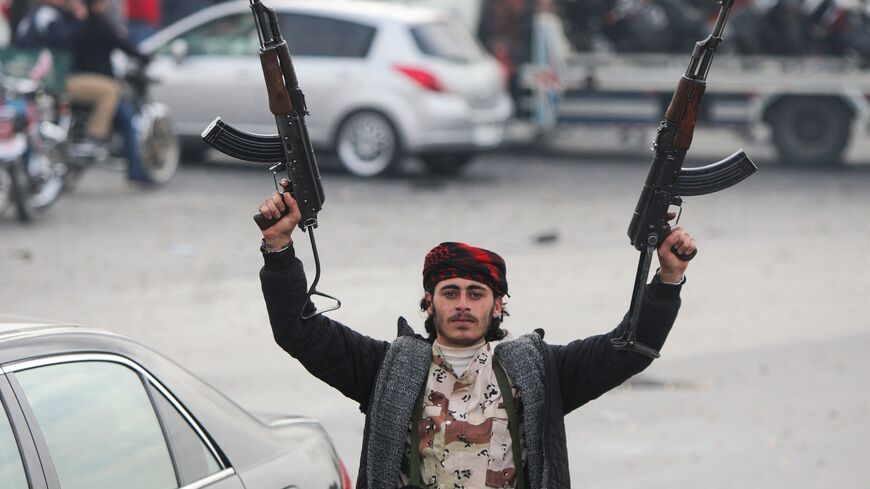 An anti-government fighter celebrates at Umayyad Square in Damascus, on Dec. 8, 2024. 