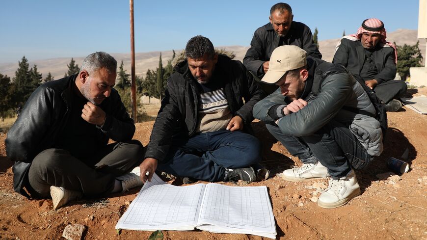 People examine documents at Sednaya Prison, where thousands of people were said to be detained and tortured by the Assad regime.