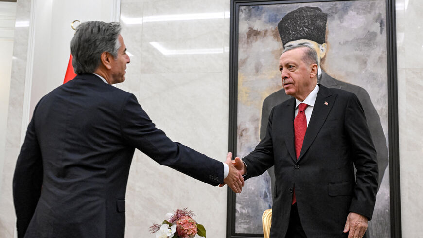 US Secretary of State Antony Blinken (L) shakes hands with Turkey's President Recep Tayyip Erdogan (R) before a picture of the founder and first president of the Turkish Republic Mustafa Kemal Ataturk, during their meeting at Ankara Esenboga Airport on December 12, 2024. (Photo by ANDREW CABALLERO-REYNOLDS / POOL / AFP) (Photo by ANDREW CABALLERO-REYNOLDS/POOL/AFP via Getty Images)