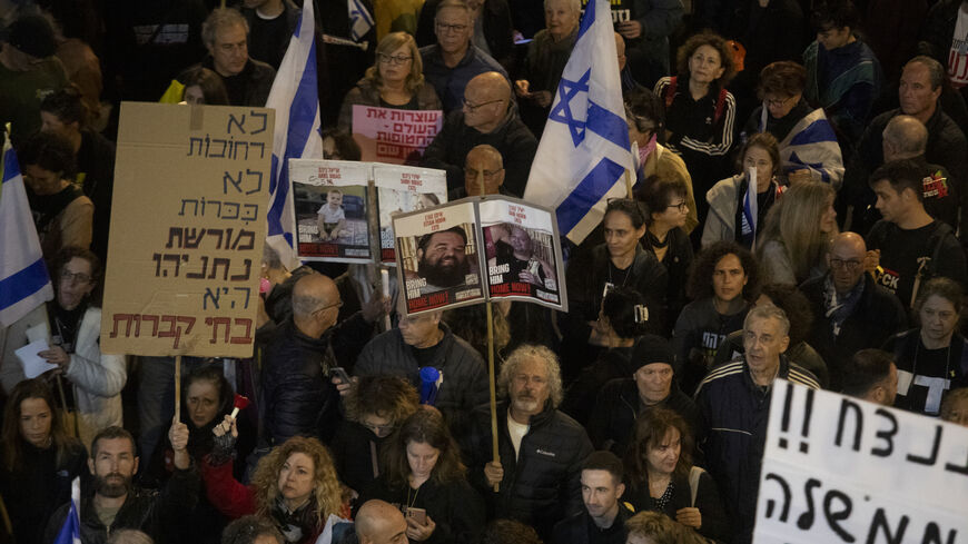 Families of hostages and supporters hold signs during a rally calling for the Israeli government to seal a hostages deal with Hamas on Dec. 14, 2024 in Tel Aviv, Israel. 