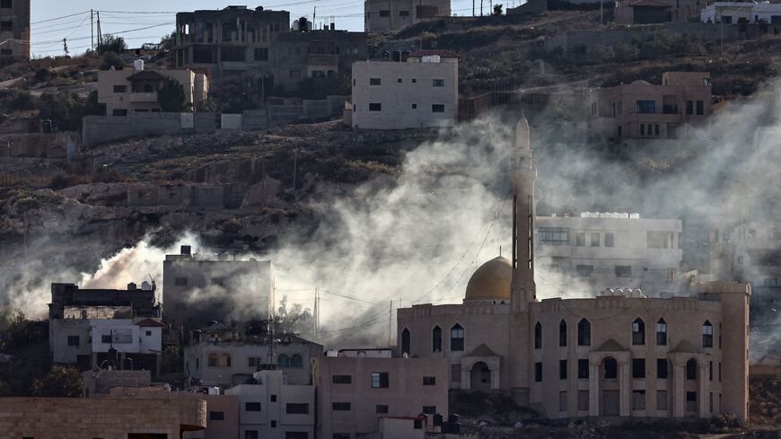 Smoke rises following an explosion amid clashes between Palestinian Authority security forces and militants in the Jenin camp in the Israel-occupied West Bank on Dec. 15, 2024. 