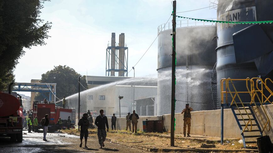 Yemeni firefighters douse oil tanks with water at a power station hit in an Israeli airstrike in the Houthi-run capital, Sanaa, Dec. 19, 2024.