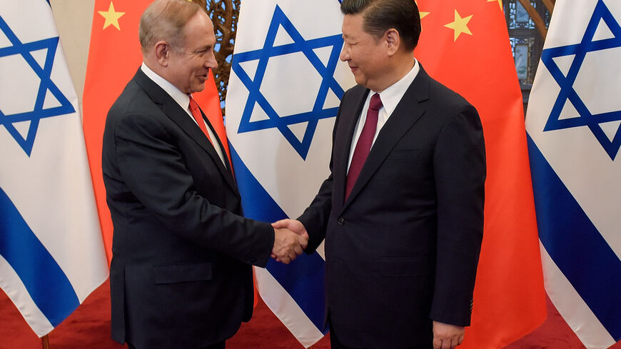 China's President Xi Jinping (R) and Israel's Prime Minister Benjamin Netanyahu shake hands ahead of their talks at Diaoyutai State Guesthouse in Beijing on March 21, 2017. / AFP PHOTO / POOL / Etienne Oliveau (Photo credit should read ETIENNE OLIVEAU/AFP via Getty Images)