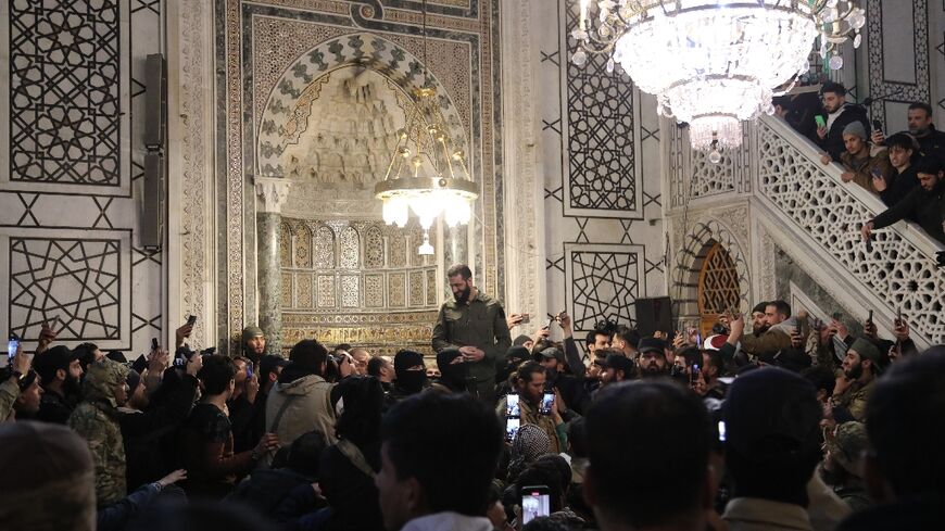 The leader of Syria's Islamist Hayat Tahrir al-Sham group that seized Damascus, Abu Mohammed al-Jolani, addresses a crowd at the capital's landmark Umayyad Mosque on December 8, 2024