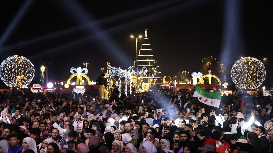 People celebrate the New Year near Umayyad Square in Damascus, Syria