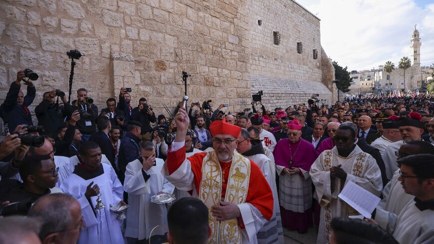 Latin Patriarch of Jerusalem Pierbattista Pizzaballa leads a Christmas procession outside the Church of the Nativity in Bethlehem