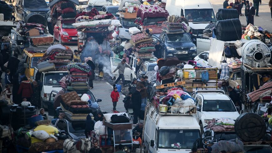 Displaced Palestinians hoping to return to northern Gaza wait along Salah al-Din road near the blocked Netzarim corridor, after a last-minute dispute halted their return during a truce between Israel and Hamas