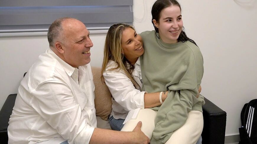 In a photo released by the Israeli military, freed Israeli hostage Agam Berger is reunited with her parents after her release by Hamas militants in the Gaza Strip