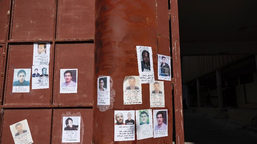 Pictures of missing people hang on the main gate of Syria's Saydnaya prison, which epitomises the atrocities of the ousted Assad government