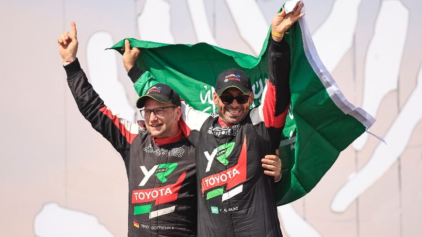 Saudi driver Yazeed Al Rajhi (R) and co-driver Edouard Boulanger (L) celebrate after winning the Dakar Rally